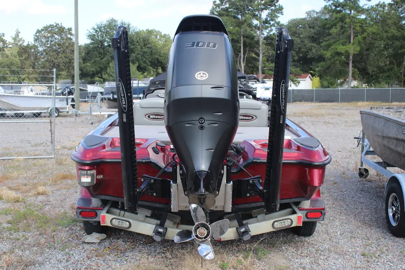 Slide: The Image of 2009 Triton 21X3 Pro DC boat with powerful outboard motor, parked outdoors. - 17
