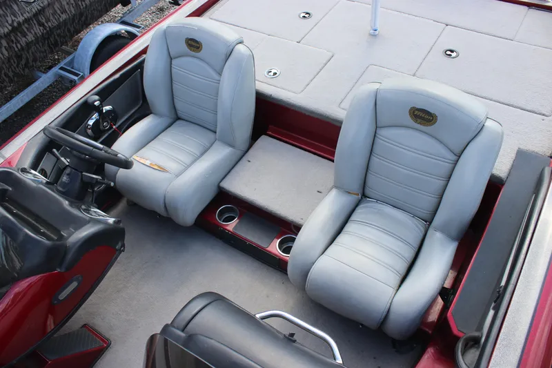 Slide: The Image of 2009 Triton 21X3 Pro DC boat interior with gray seats and steering wheel. - 18