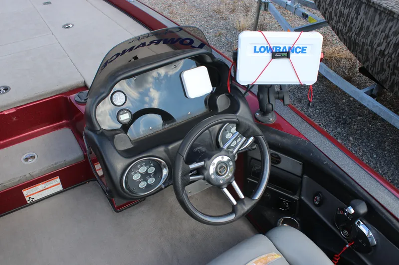 Slide: The Image of 2009 Triton 21X3 Pro DC boat dashboard with steering wheel and Lowrance GPS system. - 19