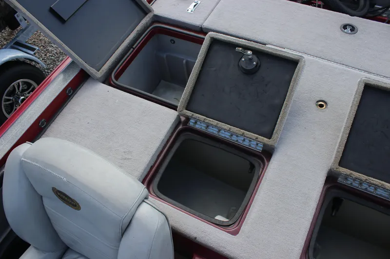 Slide: The Image of 2009 Triton 21X3 Pro DC boat storage compartments and seating area. - 20