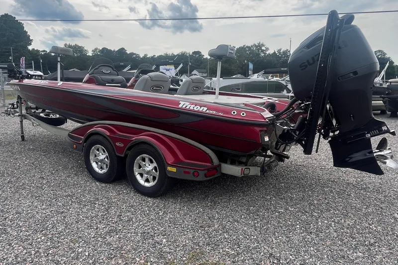 Slide: The Image of 2009 Triton 21X3 Pro DC boat with Suzuki engine on a trailer, parked on gravel. - 7