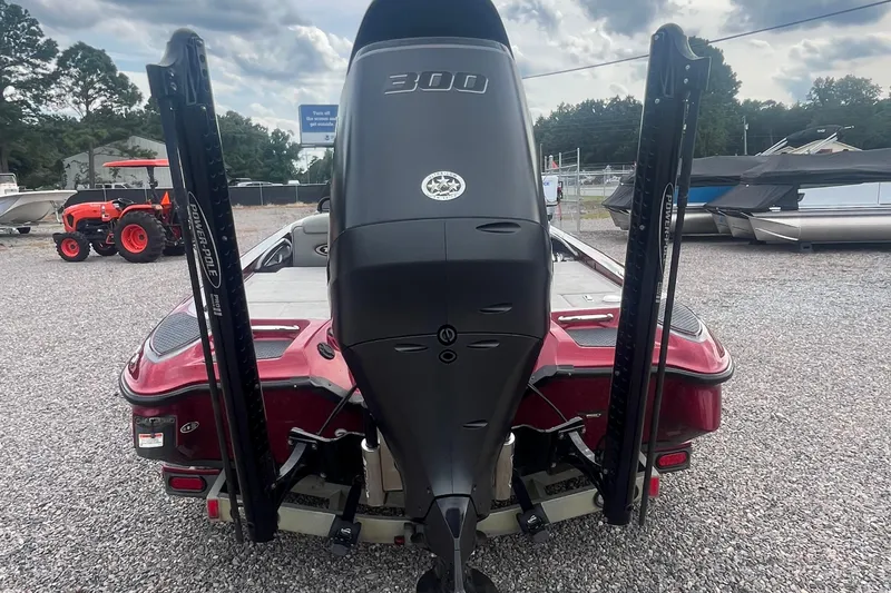 Slide: The Image of 2009 Triton 21X3 Pro DC boat with powerful outboard motor, parked on gravel. - 8
