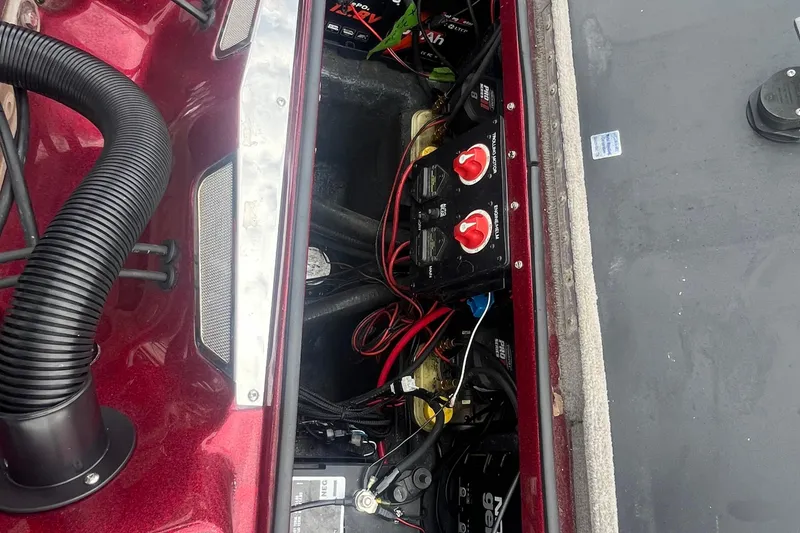 Slide: The Image of 2009 Triton 21X3 Pro DC boat battery compartment with wiring and switches. - 9