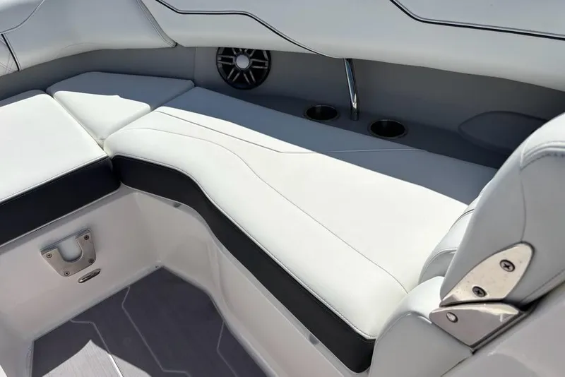 Slide: The Image of 2023 Regal LX4 boat interior with white cushioned seating and cup holders. - 5