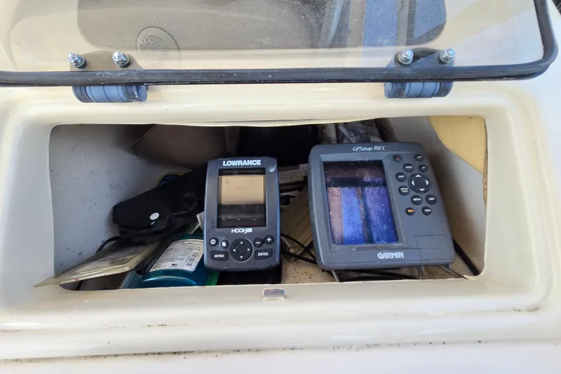 Slide: The Image of 2004 Grady-White Journey 258 boat dashboard with Lowrance and Garmin navigation devices. - 4