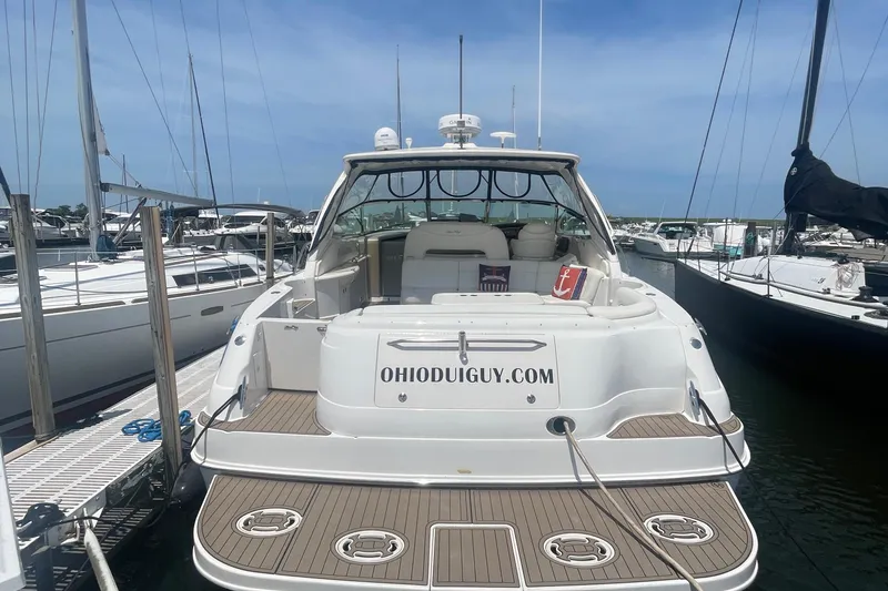 Slide: The Image of 2001 Sea Ray 460 Sundancer yacht docked at marina, rear view with website URL displayed. - 2