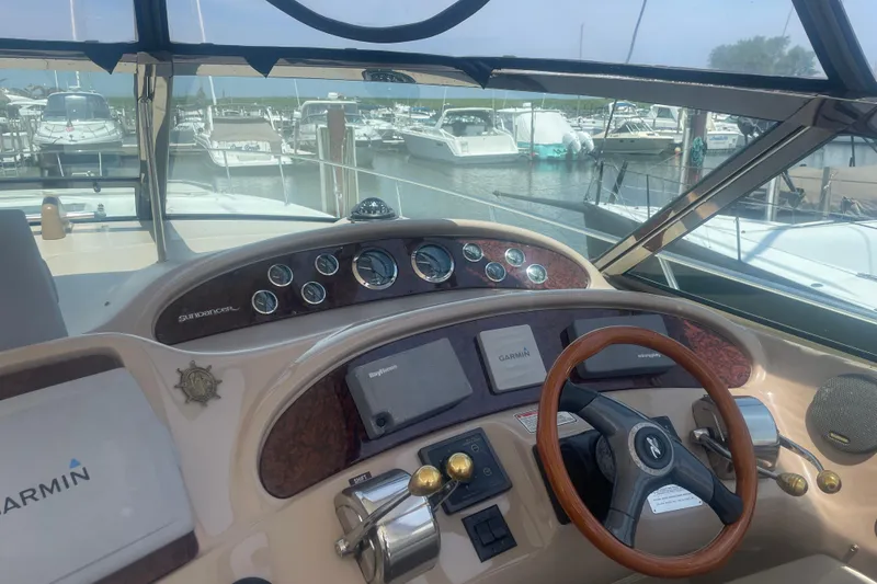 Slide: The Image of Cockpit view of 2001 Sea Ray 460 Sundancer yacht with steering wheel and navigation instruments. - 6
