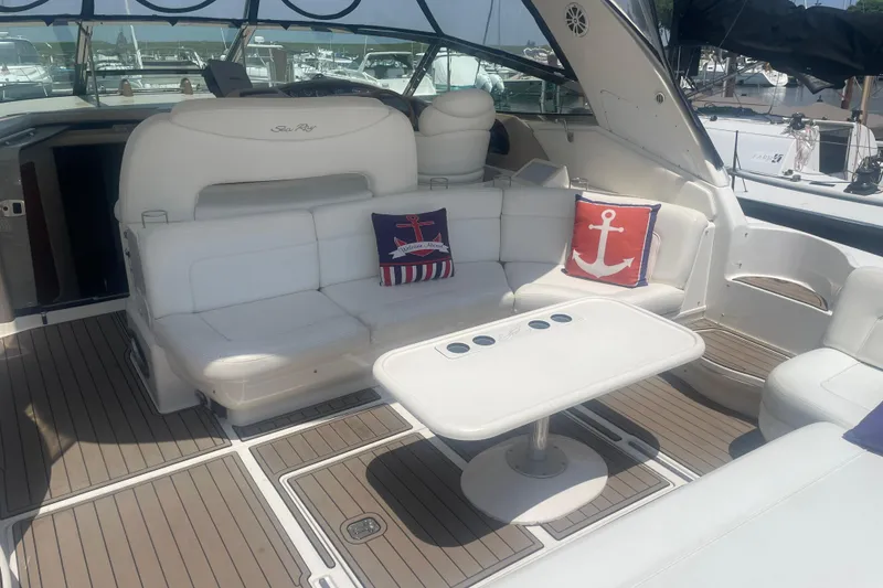Slide: The Image of Luxurious 2001 Sea Ray 460 Sundancer yacht interior with white seating and nautical-themed cushions. - 8