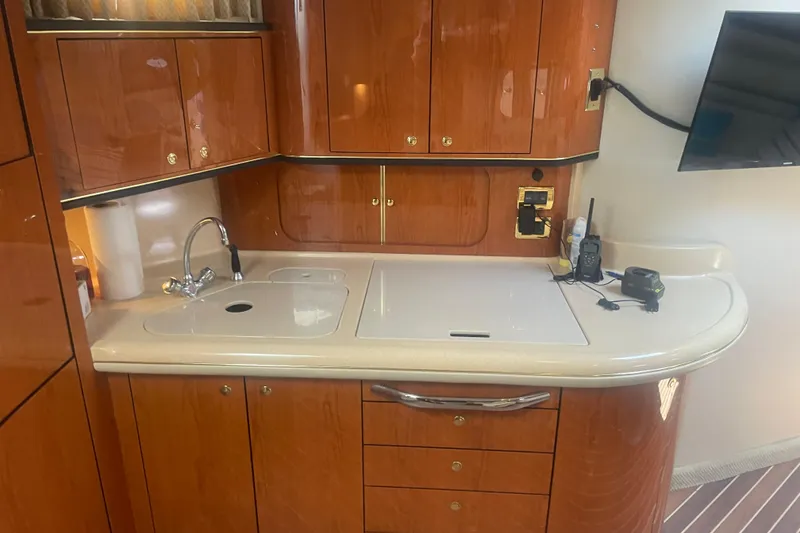 Slide: The Image of Luxurious 2001 Sea Ray 460 Sundancer yacht kitchen with wood cabinetry and modern amenities. - 9