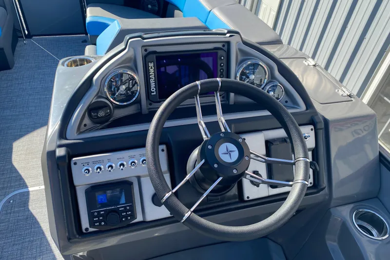 Slide: The Image of 2023 Berkshire 23UL boat dashboard with steering wheel and control panel. - 12