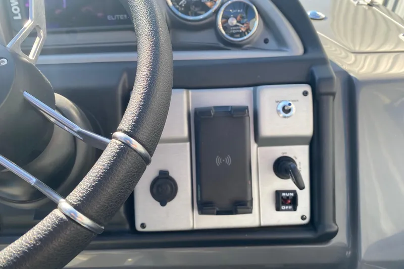 Slide: The Image of Steering wheel and control panel of 2023 Berkshire 23UL boat. - 15