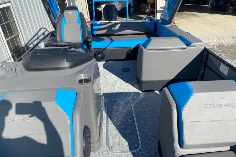 Slide: The Image of 2023 Berkshire 23UL pontoon boat interior with gray and blue seating, modern design. - 20