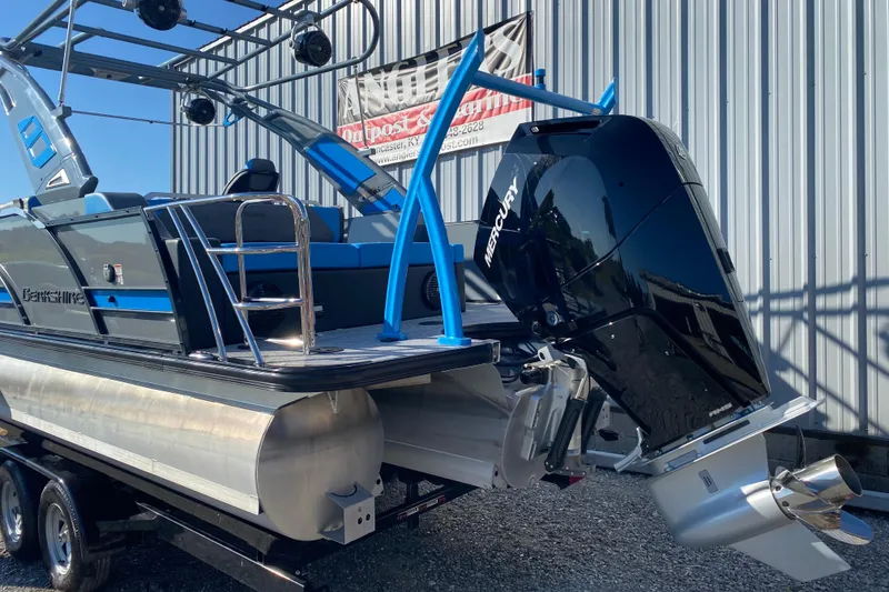 Slide: The Image of 2023 Berkshire 23UL pontoon boat with Mercury outboard motor, parked on a trailer. - 5