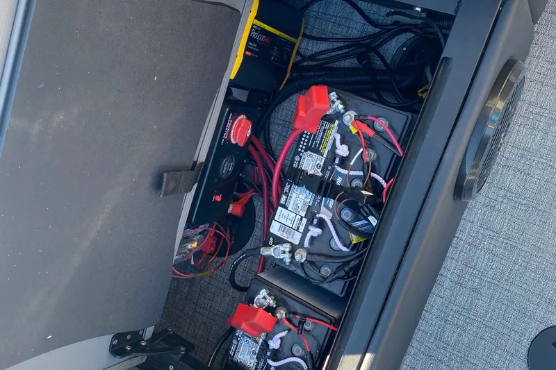 Slide: The Image of Battery compartment of 2023 Berkshire 23UL boat with wiring and components. - 9