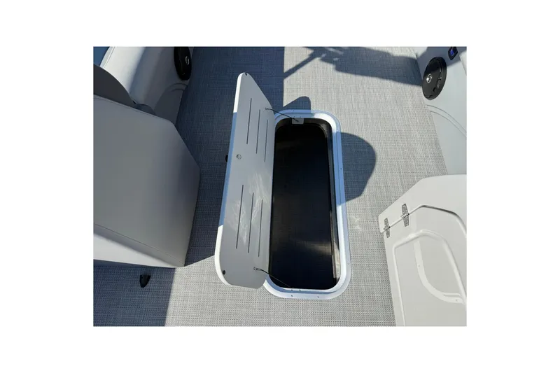 Slide: The Image of 2025 Bentley Pontoons Legacy 243 Swingback storage compartment open on deck. - 12