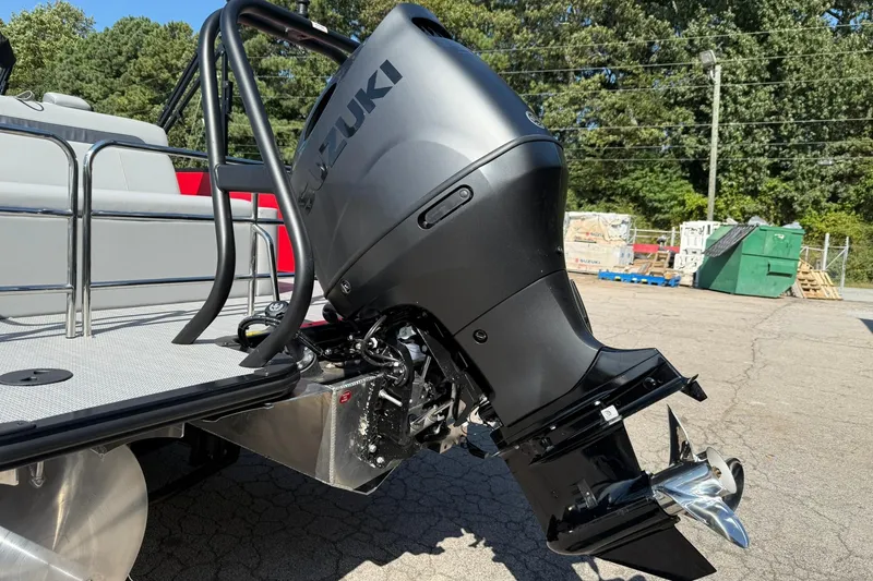 Slide: The Image of 2025 Bentley Pontoons Legacy 243 Swingback with Suzuki outboard motor, parked outdoors. - 16