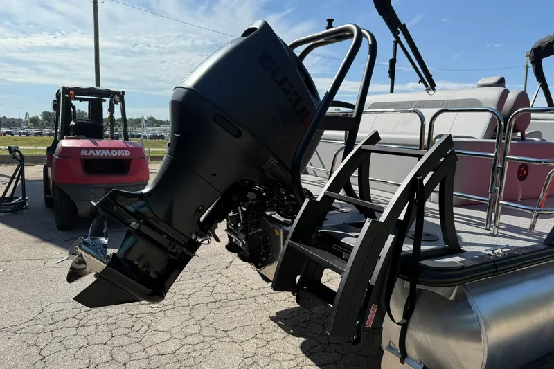 Slide: The Image of 2025 Bentley Pontoons Legacy 243 Swingback with Suzuki outboard motor, docked on pavement. - 17