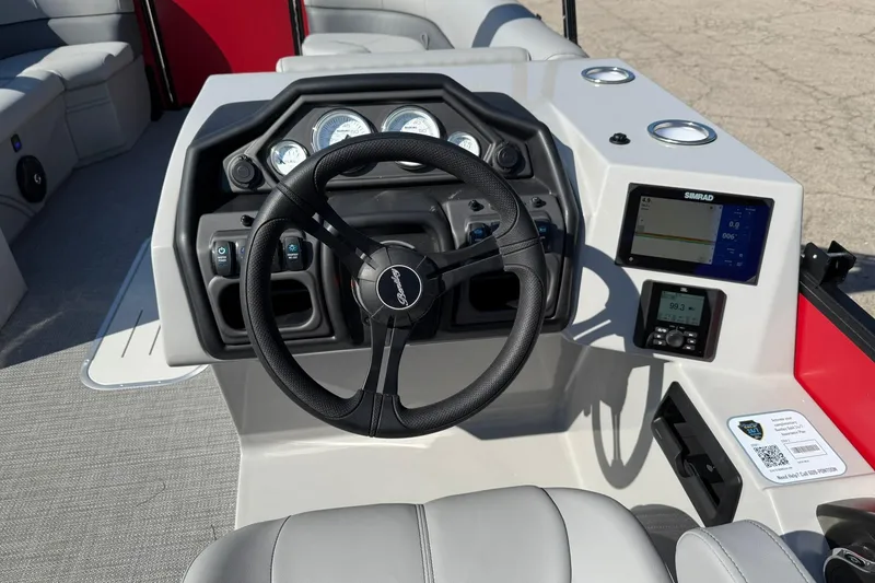 Slide: The Image of 2025 Bentley Pontoons Legacy 243 Swingback dashboard with steering wheel and digital display. - 6