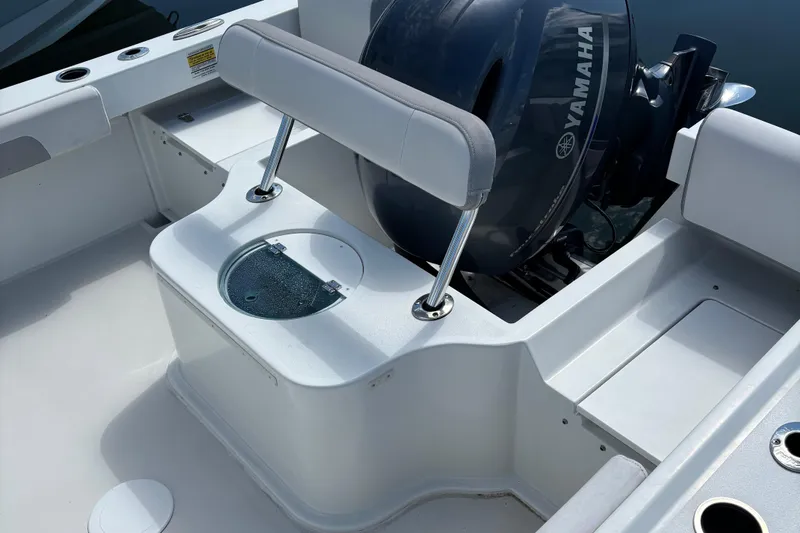 Slide: The Image of 2022 Parker 2120 Sport Cabin boat interior with Yamaha engine and seating area. - 11