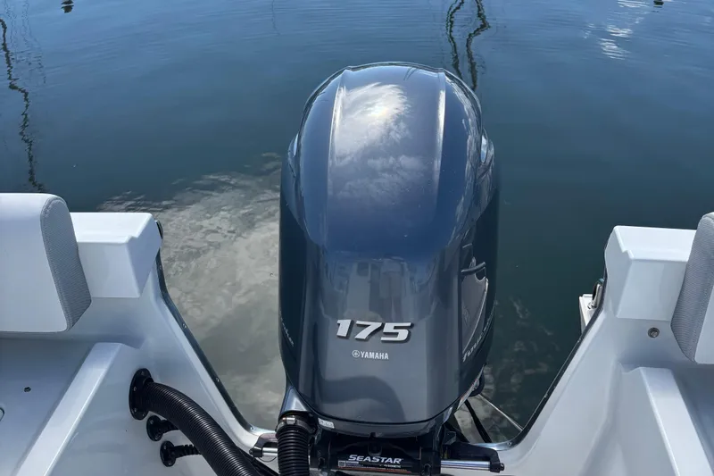 Slide: The Image of Yamaha 175 outboard motor on 2022 Parker 2120 Sport Cabin boat, docked on calm water. - 12
