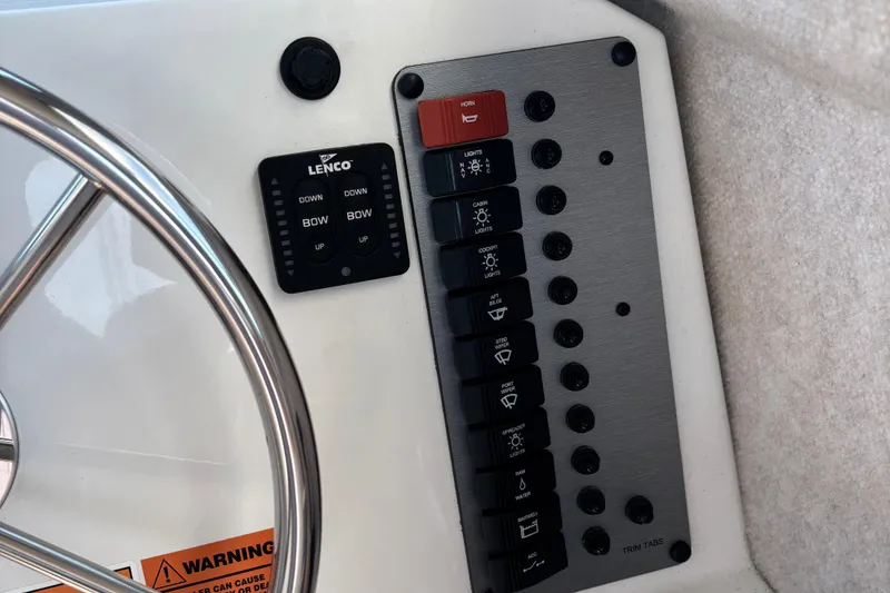 Slide: The Image of Control panel of 2022 Parker 2120 Sport Cabin boat with steering wheel and switches. - 13