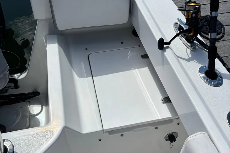 Slide: The Image of 2022 Parker 2120 Sport Cabin boat deck with fishing rod holder. - 17