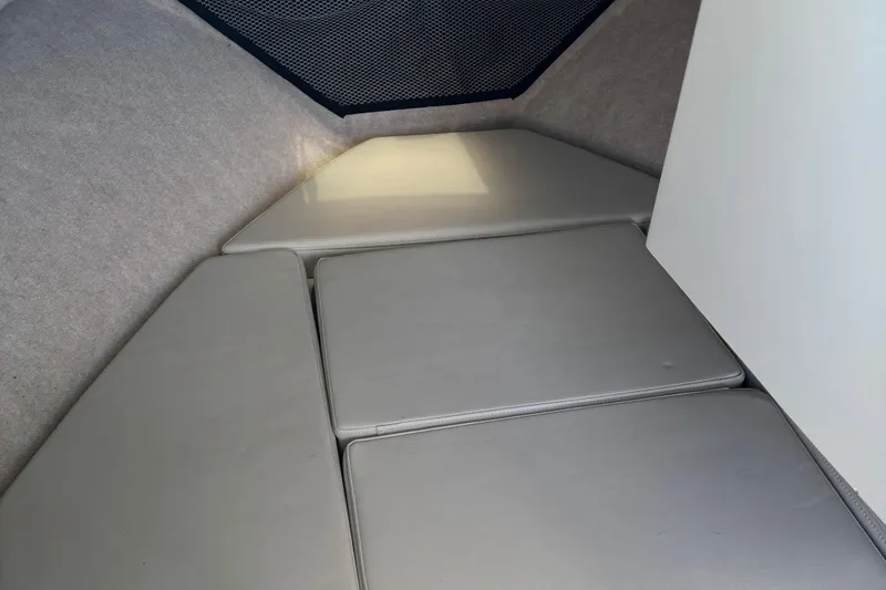 Slide: The Image of Interior cabin of 2022 Parker 2120 Sport Cabin boat with cushioned seating. - 7