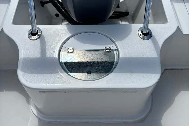 Slide: The Image of 2022 Parker 2120 Sport Cabin boat deck with livewell and rod holders. - 8