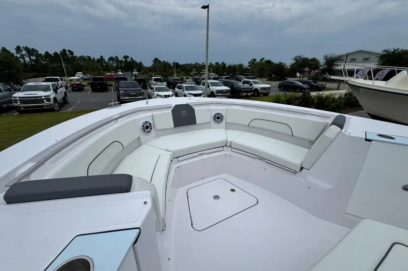 Slide: The Image of 2026 Bertram 34CC boat with spacious seating, parked near vehicles under cloudy skies. - 10