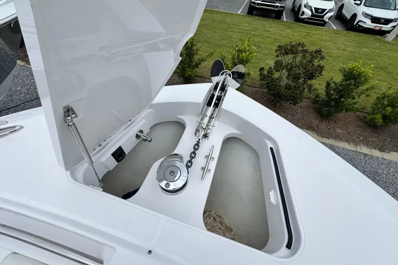 Slide: The Image of Open anchor compartment on 2026 Bertram 34CC boat, showcasing anchor chain and mechanism. - 11