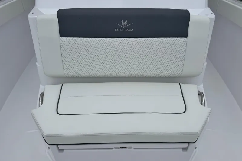 Slide: The Image of Luxury seating on 2026 Bertram 34CC boat, featuring elegant white and black upholstery. - 15