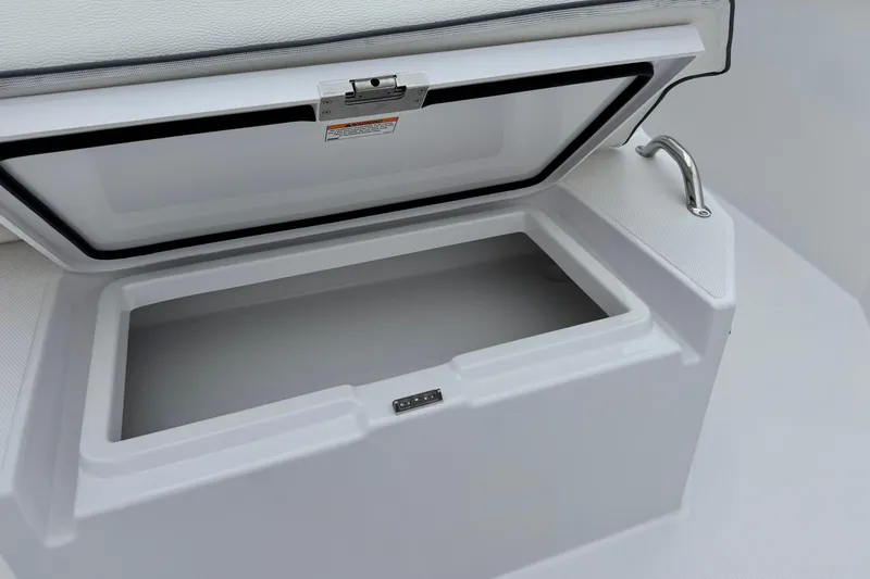 Slide: The Image of Open storage compartment on 2026 Bertram 34CC boat, featuring a sleek white design. - 16