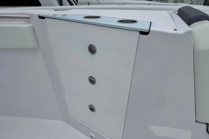 Slide: The Image of 2026 Bertram 34CC boat interior with sleek storage drawers and cup holders. - 18