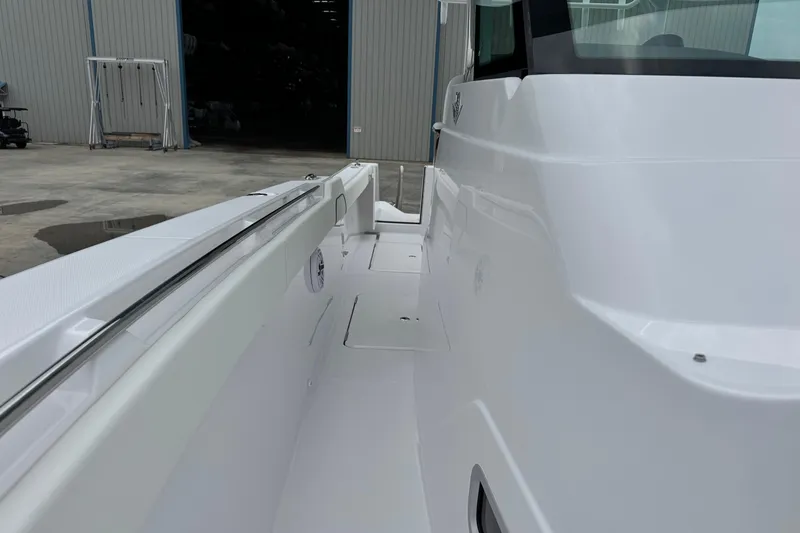 Slide: The Image of 2026 Bertram 34CC boat side view, showcasing sleek white design and modern features. - 21