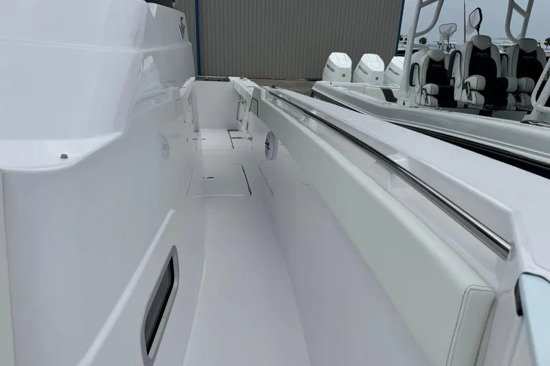 Slide: The Image of 2026 Bertram 34CC boat interior with sleek white design and modern seating. - 22