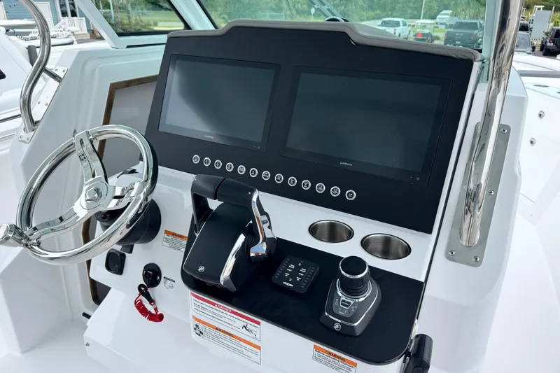 Slide: The Image of 2026 Bertram 34CC boat helm with dual screens and modern controls. - 26