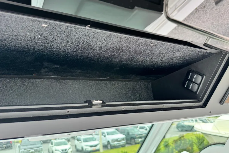 Slide: The Image of Storage compartment in a 2026 Bertram 34CC boat, featuring interior switches. - 29