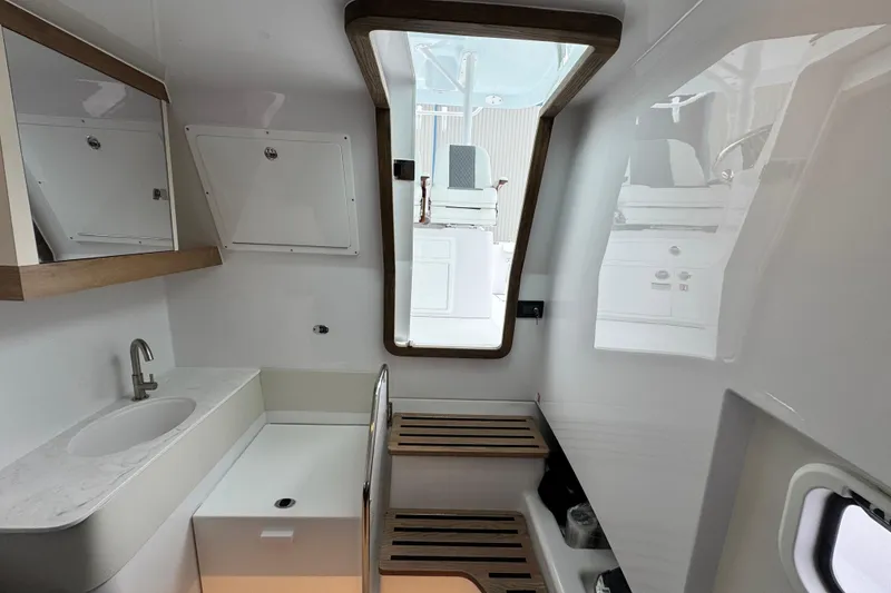 Slide: The Image of 2026 Bertram 34CC interior cabin with modern sink and wooden accents. - 33
