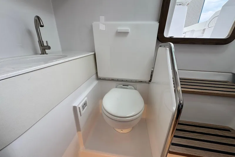 Slide: The Image of Modern bathroom in 2026 Bertram 34CC boat with toilet, sink, and window. - 35