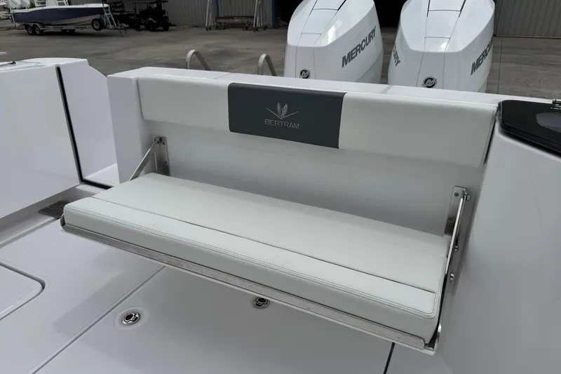 Slide: The Image of 2026 Bertram 34CC boat with white foldable bench seat and dual Mercury engines. - 41