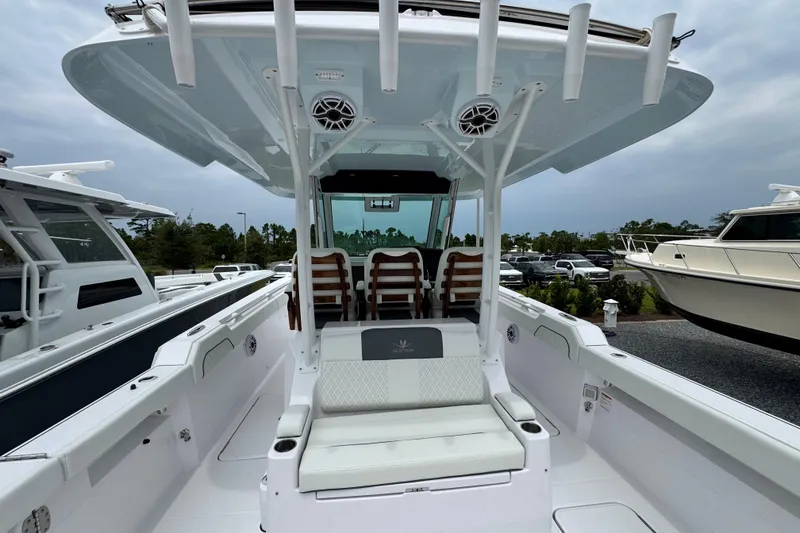Slide: The Image of 2026 Bertram 34CC boat interior with seating and canopy, docked outdoors. - 43