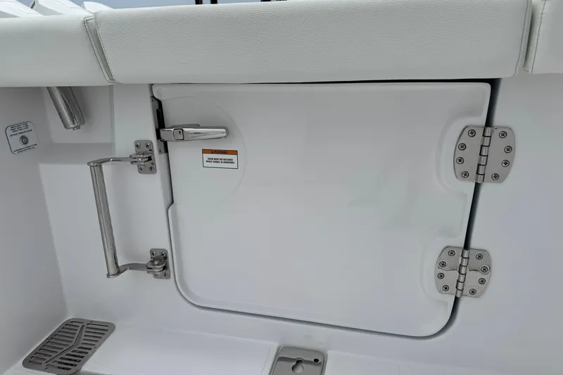 Slide: The Image of 2026 Bertram 34CC boat interior, featuring a white hatch door with stainless steel hinges. - 46