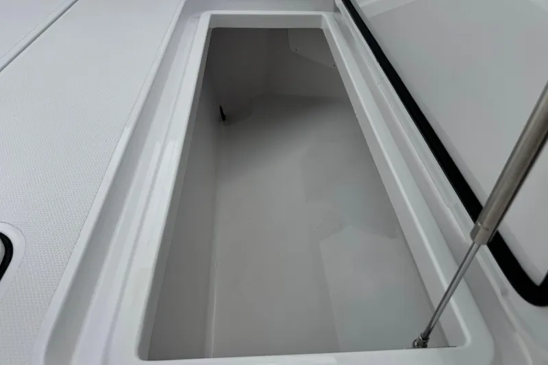 Slide: The Image of Storage compartment on 2026 Bertram 34CC boat, featuring sleek white interior design. - 47