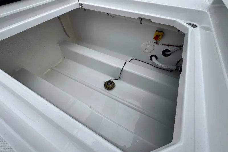 Slide: The Image of 2026 Bertram 34CC boat storage compartment with clean white interior and visible wiring. - 48