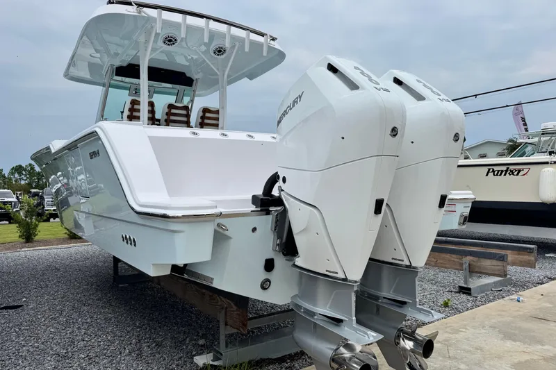 Slide: The Image of 2026 Bertram 34CC boat with dual Mercury outboard engines, displayed outdoors. - 5