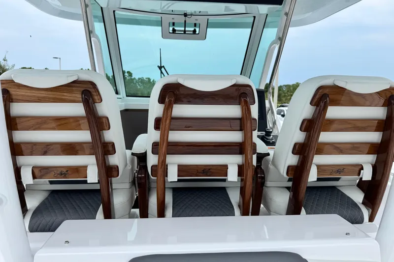 Slide: The Image of 2026 Bertram 34CC boat interior with elegant wooden and white leather seating. - 9