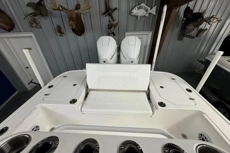 Slide: The Image of 2026 Caymas 281 HB boat interior with dual Mercury engines and seating. - 2