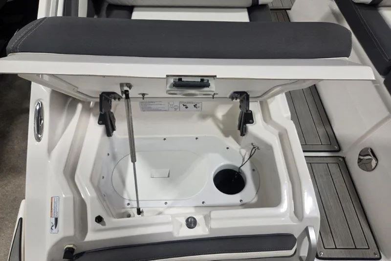 Slide: The Image of 2023 Yamaha Boats 275SDX storage compartment with open lid, showcasing interior details. - 18