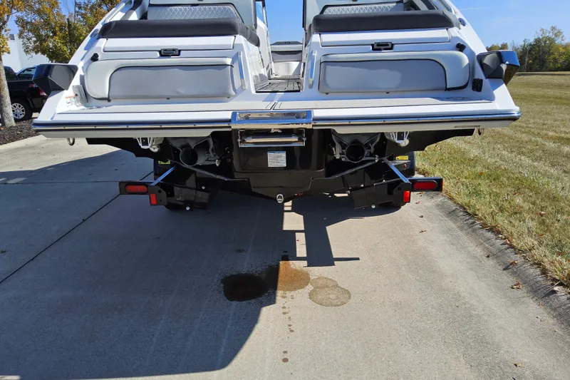 Slide: The Image of 2023 Yamaha Boats 275SDX rear view on pavement, showcasing dual engines and sleek design. - 24