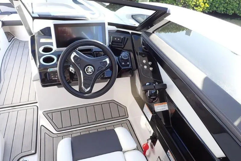 Slide: The Image of 2023 Yamaha Boats 275SDX on trailer, towed by a truck, outdoors on a sunny day. - 3